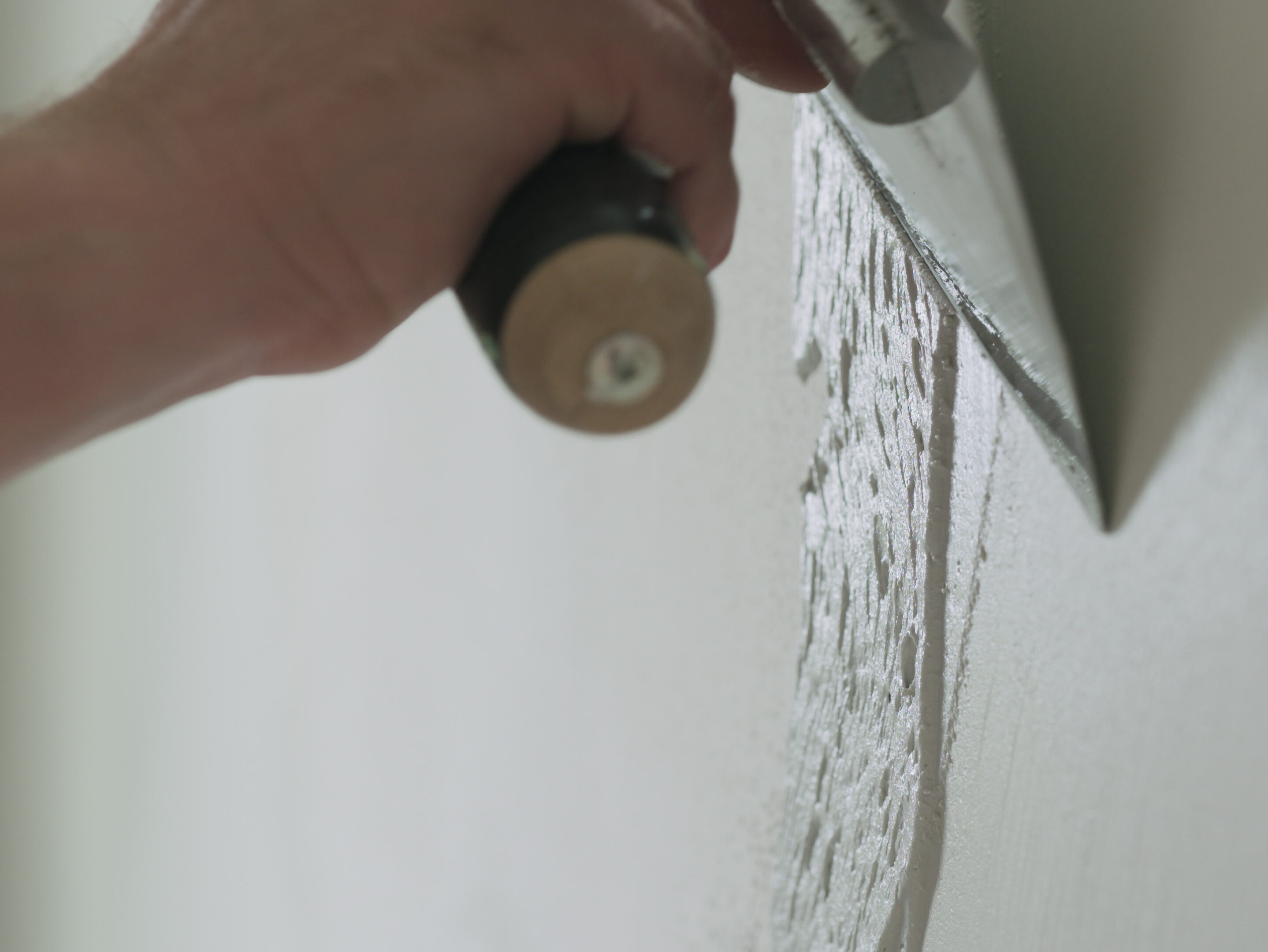 closeup worker applying decorative concrete plaster on the wall